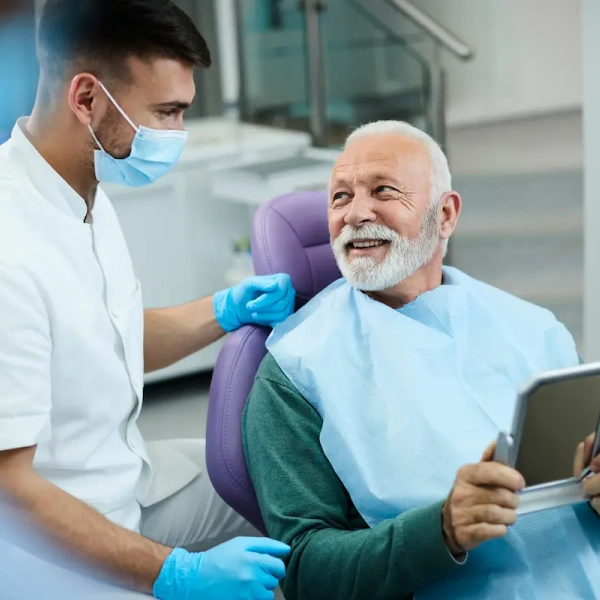 Dentist talking with an older patient during a dental visit