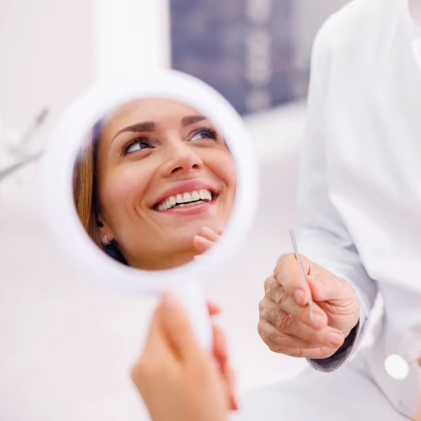 Patient smiling after conservative biomimetic dental treatment
