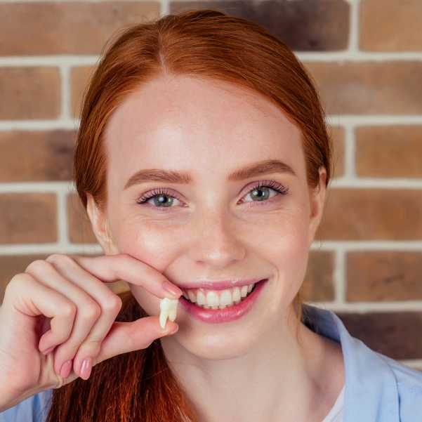 Woman smiling before a coronectomy consultation