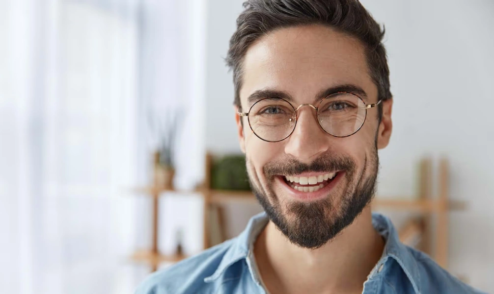 Smiling man after gummy smile treatment consultation