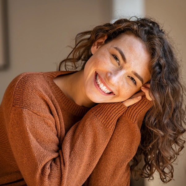 Woman smiling after retainer repair and adjustment