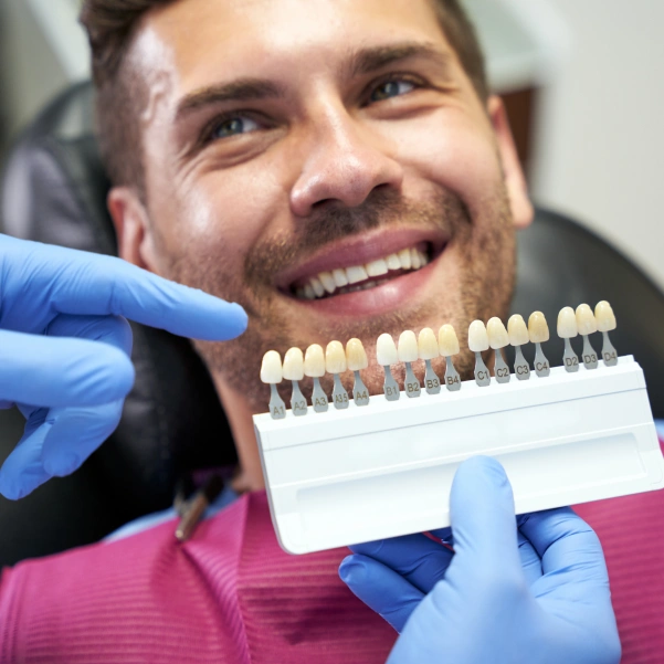 Patient comparing porcelain veneers before placement