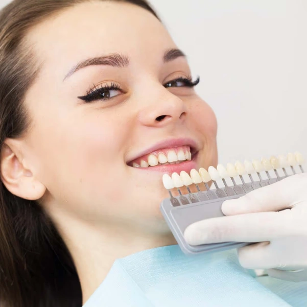 Woman smiling after porcelain veneer treatment