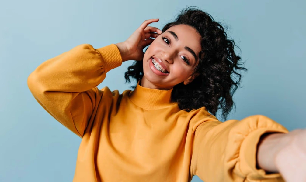 Smiling woman wearing traditional metal braces