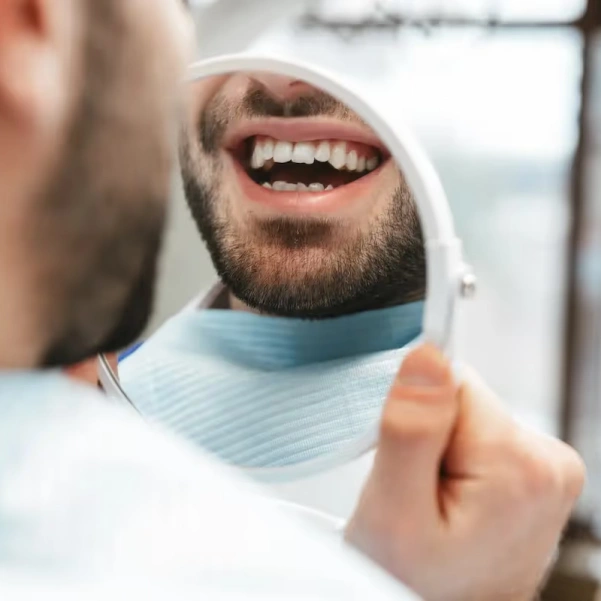 Patient smiling after receiving a tooth-colored dental filling