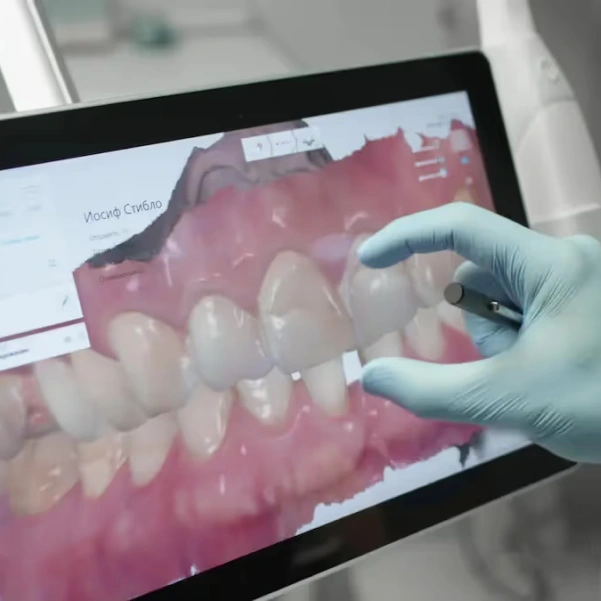 Dentist using advanced digital technology during dental treatment