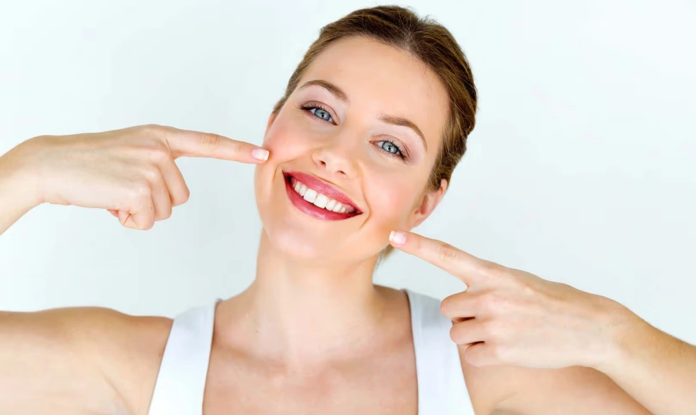 Woman showing bright teeth after professional teeth whitening