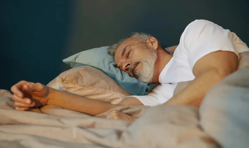 A man sleeping while using an oral appliance for sleep apnea