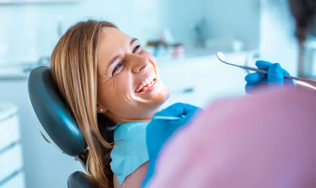 Woman smiling during a routine dental cleaning appointment