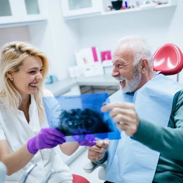 Dentist reviewing dental X-rays during a bone grafting consultation