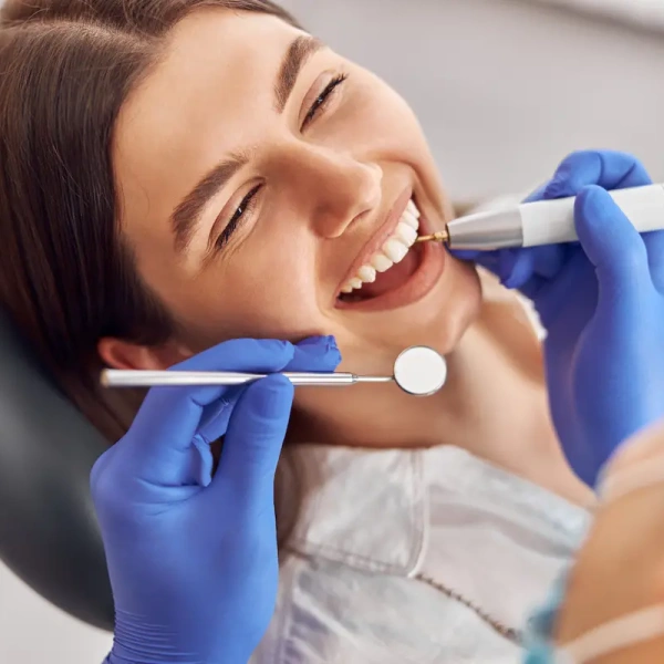 A patient smiling during a dental treatment at a modern dental clinic.