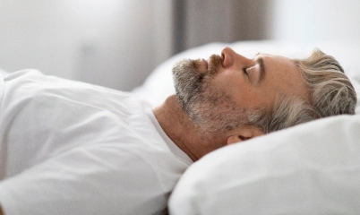 A man sleeping while using an oral appliance for sleep apnea