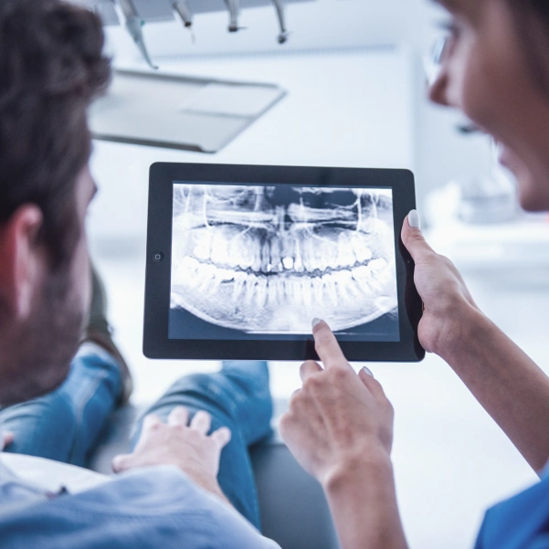 Dentist reviewing dental X-rays before an oral surgery procedure