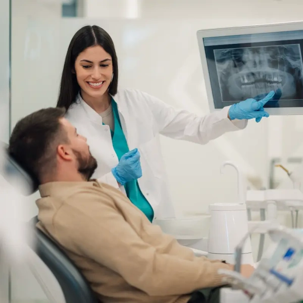 Dentist explaining dental X-rays to a patient