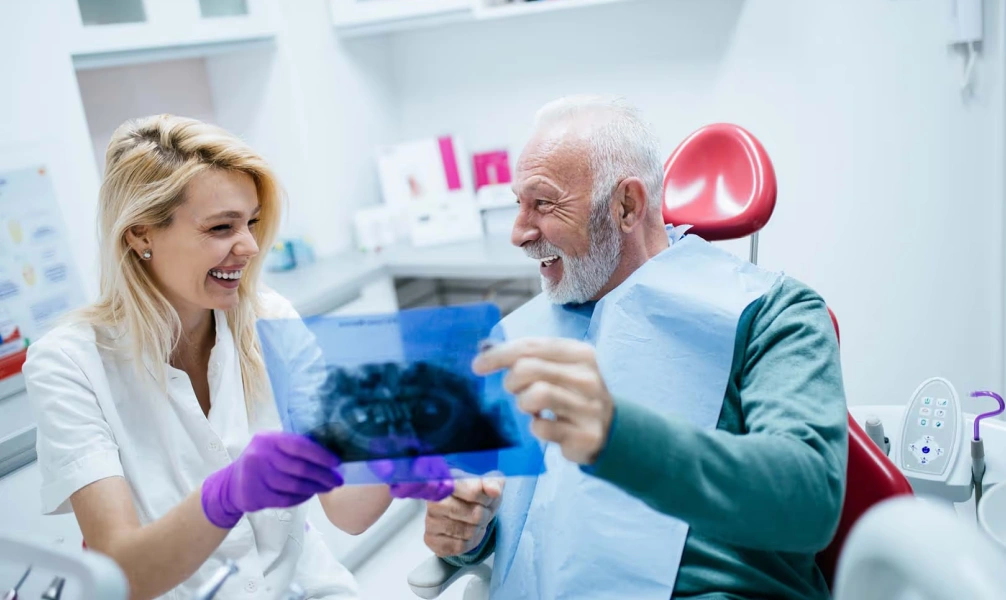 Dentist reviewing dental X-rays during a bone grafting consultation