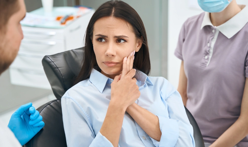 Patient discussing tooth pain during a root canal consultation