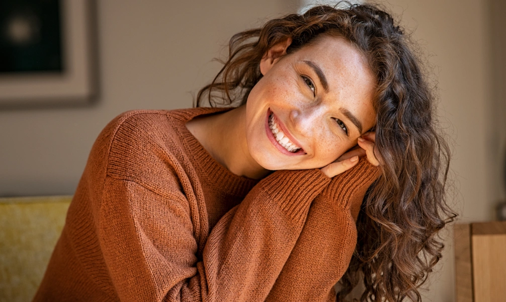 Woman smiling after retainer repair and adjustment